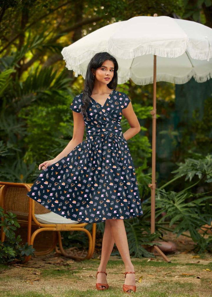 Shop the Tea Party Greta Dress by Retrolicious — vintage V-neck, gathered waist, knee length, pockets, 100% cotton. Made in USA. Sizes XS–4X.