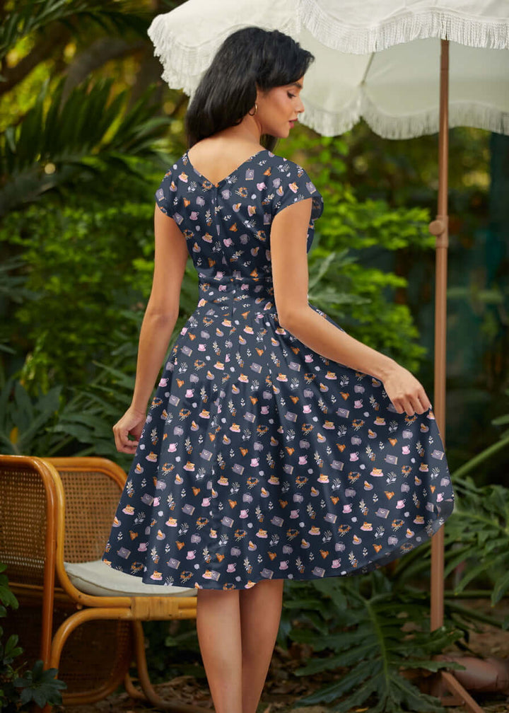 Shop the Tea Party Greta Dress by Retrolicious — vintage V-neck, gathered waist, knee length, pockets, 100% cotton. Made in USA. Sizes XS–4X.