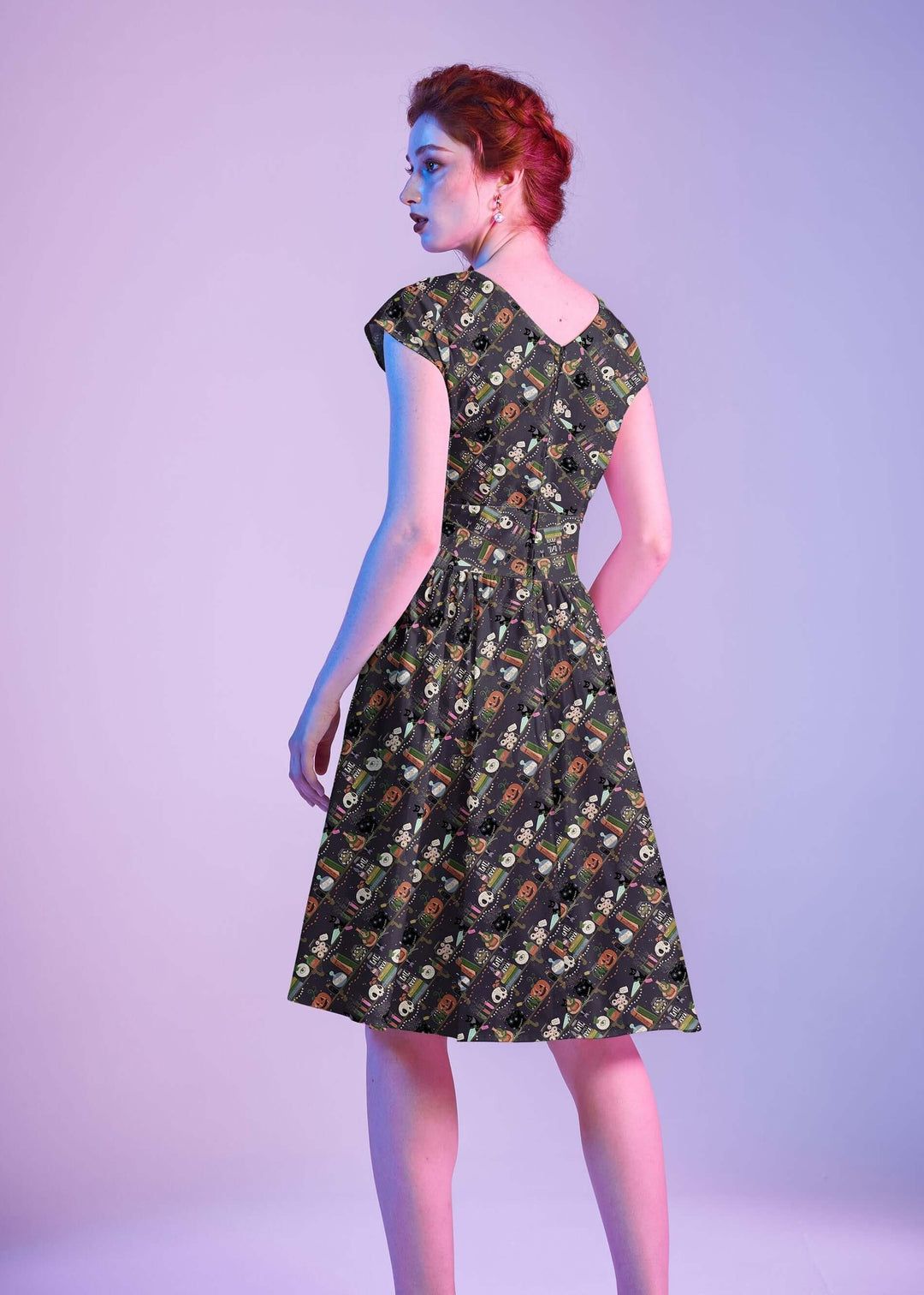 Made in USA, the Retrolicious Potions Greta dress is 100% cotton with a V-neck, gathered waist, pockets, and a true-to-size fit. Sizes XS–4X.