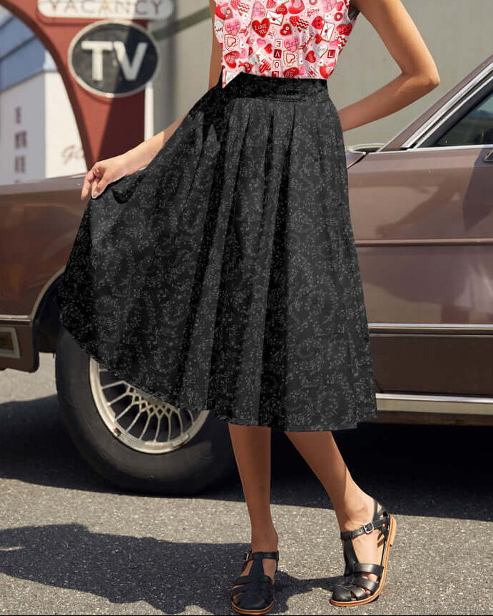 Made in USA. Shop the Music Notes Doris cotton skirt by Retrolicious, with a longer pleated silhouette, pockets and elasticized back waist. 