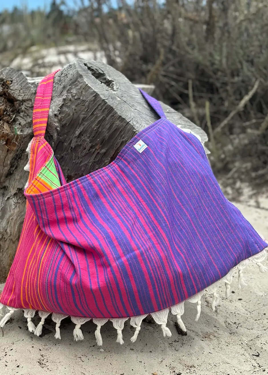 Shop the Beachables Striped 3-in-1 Turkish Cotton Beach Bag – converts from bag to towel to chair cover. Sand-resistant, quick-dry, machine washable. Made in USA.