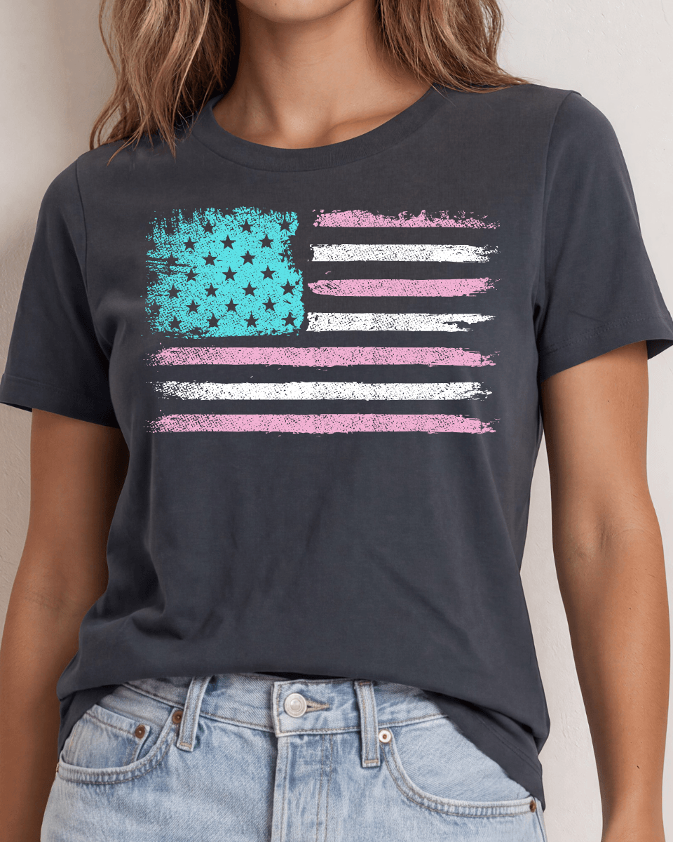 Distressed American flag graphic tee in aqua, pink & white on graphite. 100% cotton, USA-milled fabric, made in USA. A feminine patriotic twist.