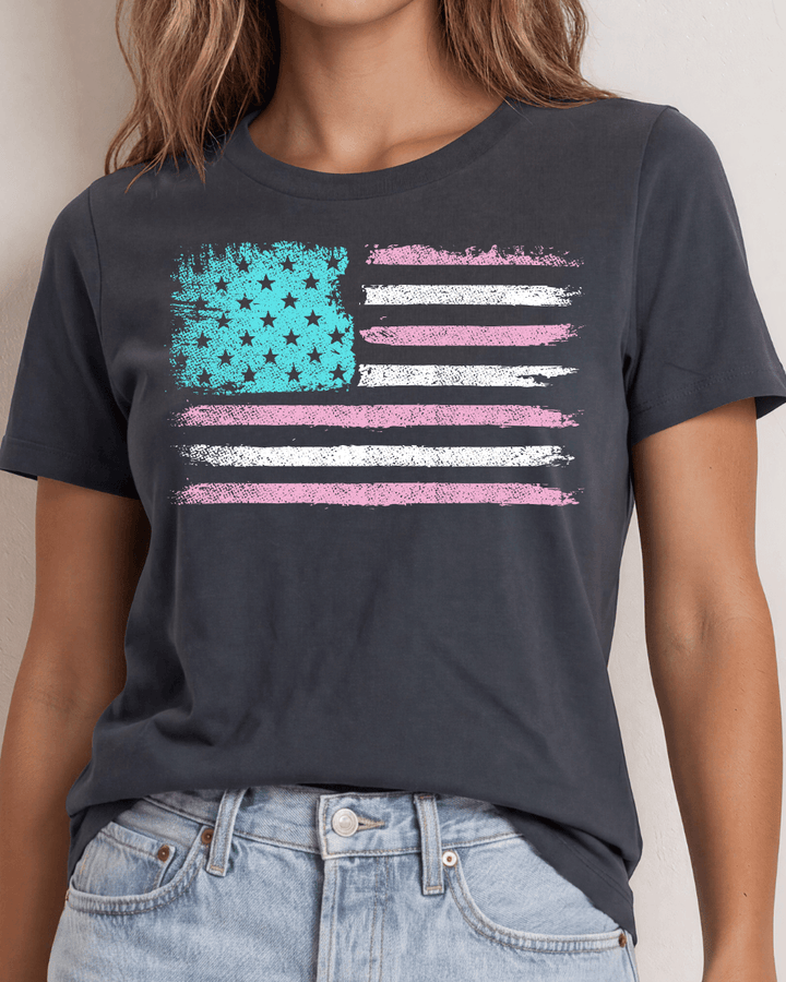 Distressed American flag graphic tee in aqua, pink &amp; white on graphite. 100% cotton, USA-milled fabric, made in USA. A feminine patriotic twist.