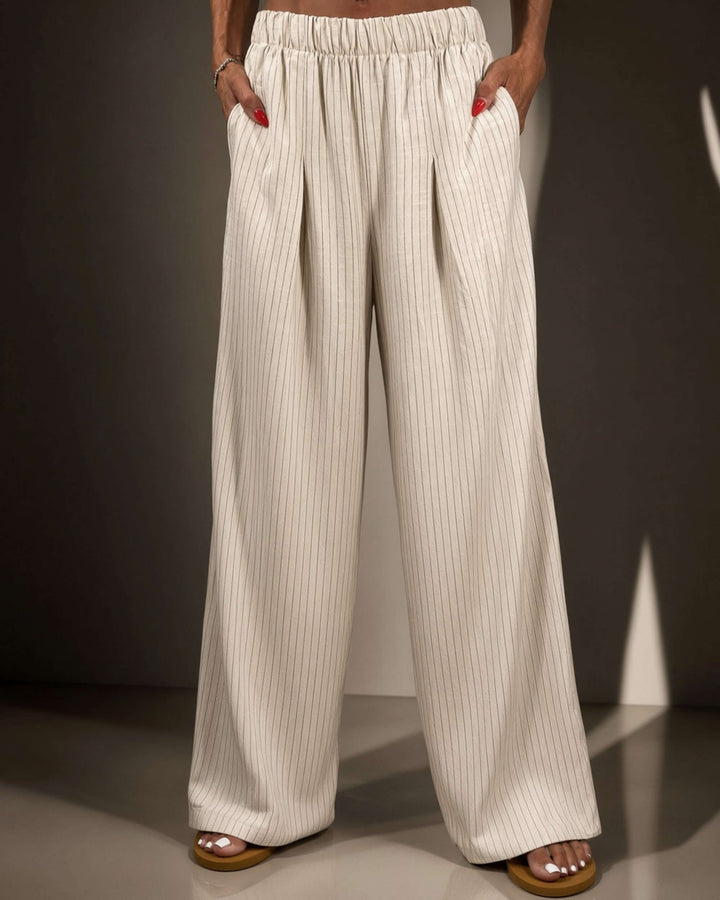 Avery high-rise wide leg pinstripe pant in ivory. Elastic waist, pleated front, full length. 85% rayon, 15% linen. Made in USA. Sizes S–L.