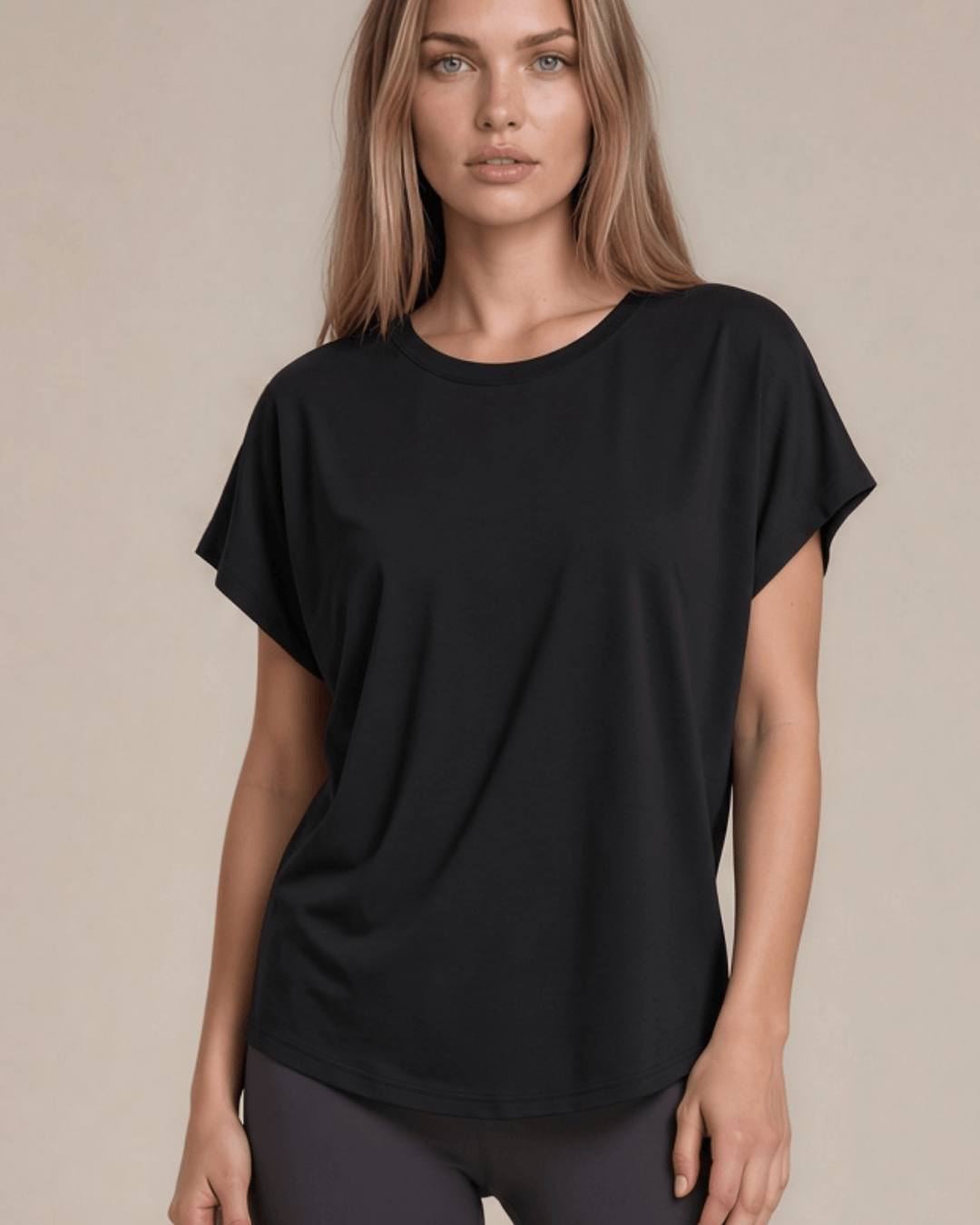Women's viscose bamboo & organic cotton poncho tee in black. Super soft, breathable, cooling, dolman fit. Sustainably made in USA. Sizes XS–XL.