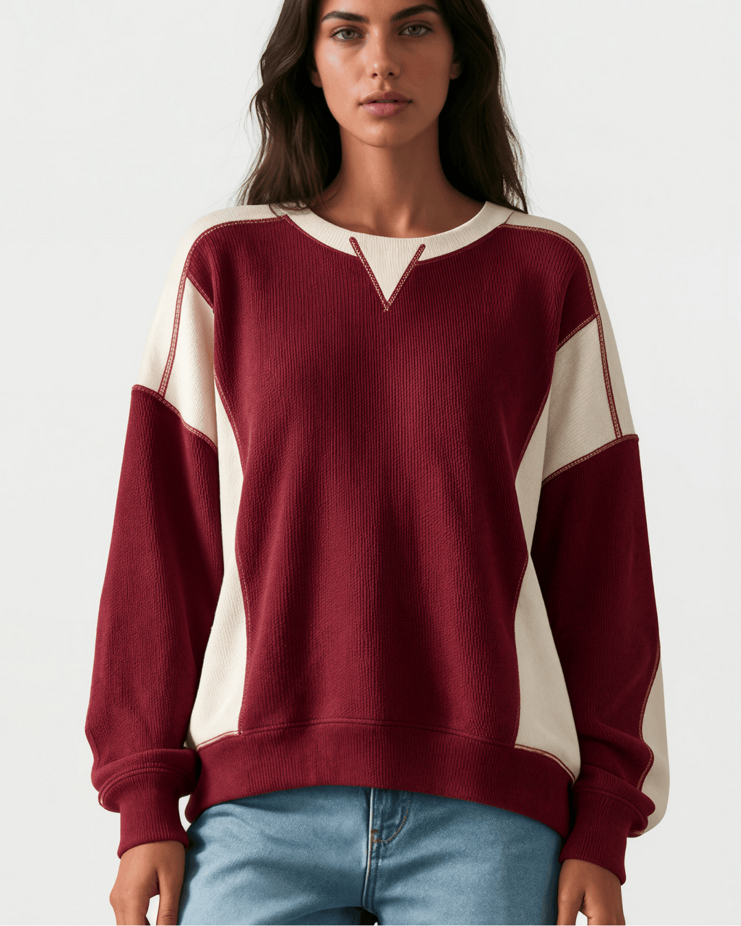 Made in USA. Burgundy & cream color block ribbed knit sweatshirt. Notched neck, exposed seams, oversized fit. 97% polyester. Sizes S–XL.