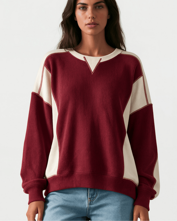 Made in USA. Burgundy &amp; cream color block ribbed knit sweatshirt. Notched neck, exposed seams, oversized fit. 97% polyester. Sizes S–XL.