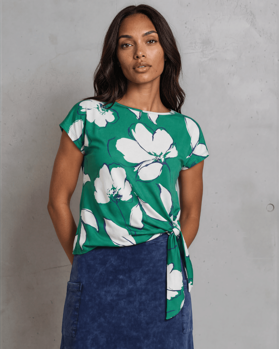 Shop the Farrah Floral Knot Top in bold green &amp; white. Semi-fitted, side knot detail, cap sleeves, sizes S-L. 95% Poly/5% Spandex. Made in USA.