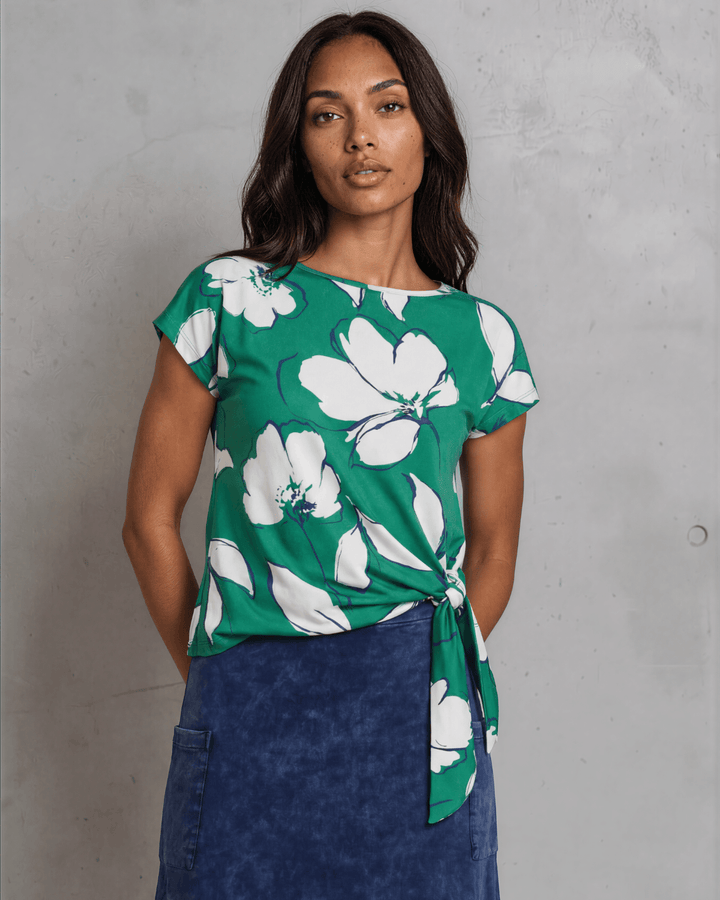 Shop the Farrah Floral Knot Top in bold green &amp; white. Semi-fitted, side knot detail, cap sleeves, sizes S-L. 95% Poly/5% Spandex. Made in USA.
