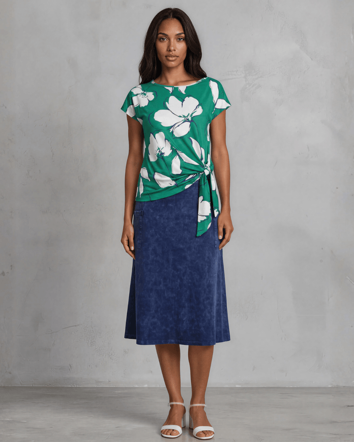 Shop the Farrah Floral Knot Top in bold green &amp; white. Semi-fitted, side knot detail, cap sleeves, sizes S-L. 95% Poly/5% Spandex. Made in USA.
