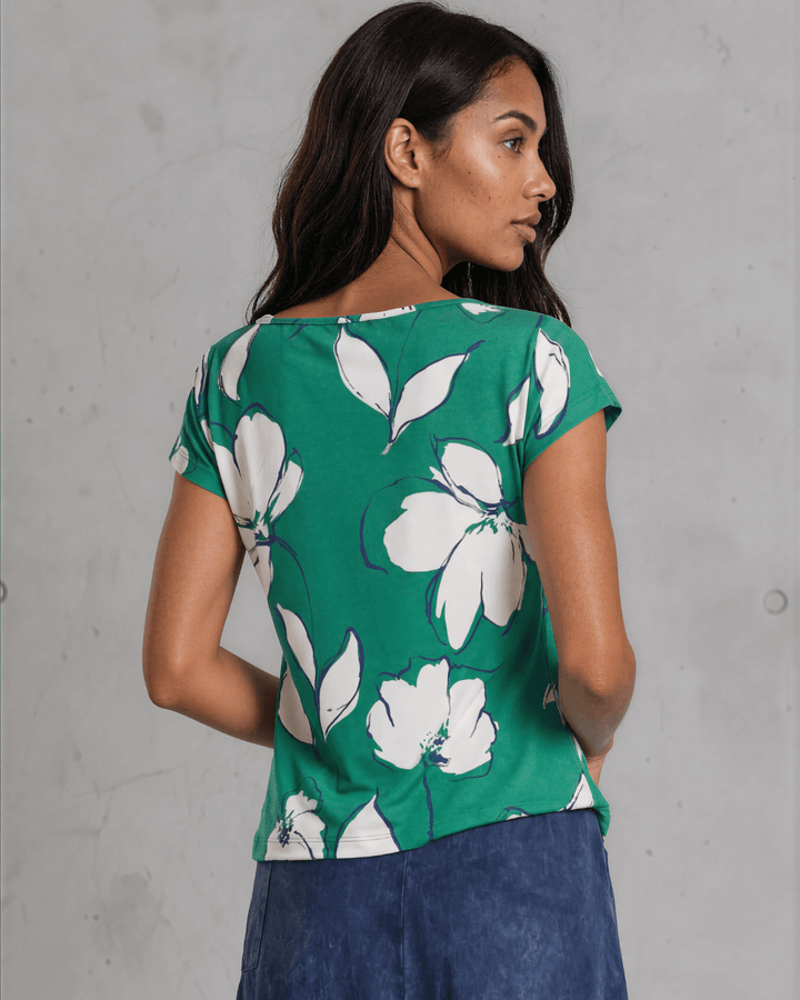 Shop the Farrah Floral Knot Top in bold green &amp; white. Semi-fitted, side knot detail, cap sleeves, sizes S-L. 95% Poly/5% Spandex. Made in USA.