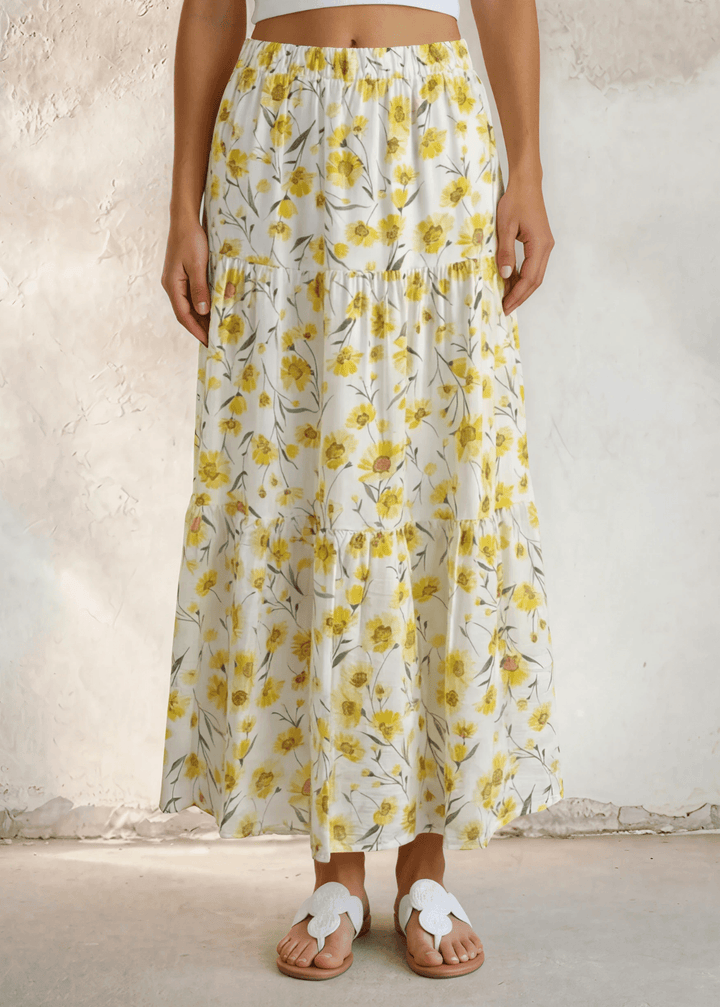 Sunshine meets style — the Sara Sunflower Bloom Maxi Skirt features a yellow floral print, three flowy tiers, and an elastic waist. Made in USA.