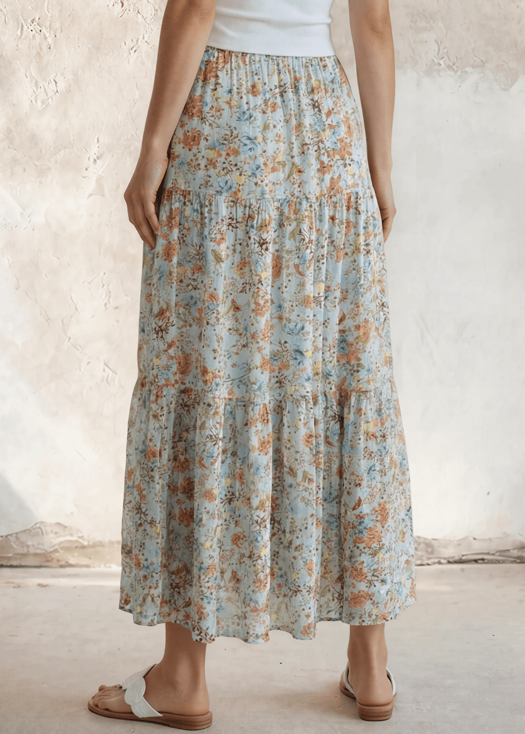 Stunning three-tiered floral pleated maxi skirt in sky blue — 100% rayon, elastic waist, flowy fit. Perfect for spring &amp; summer events. Made in USA.
