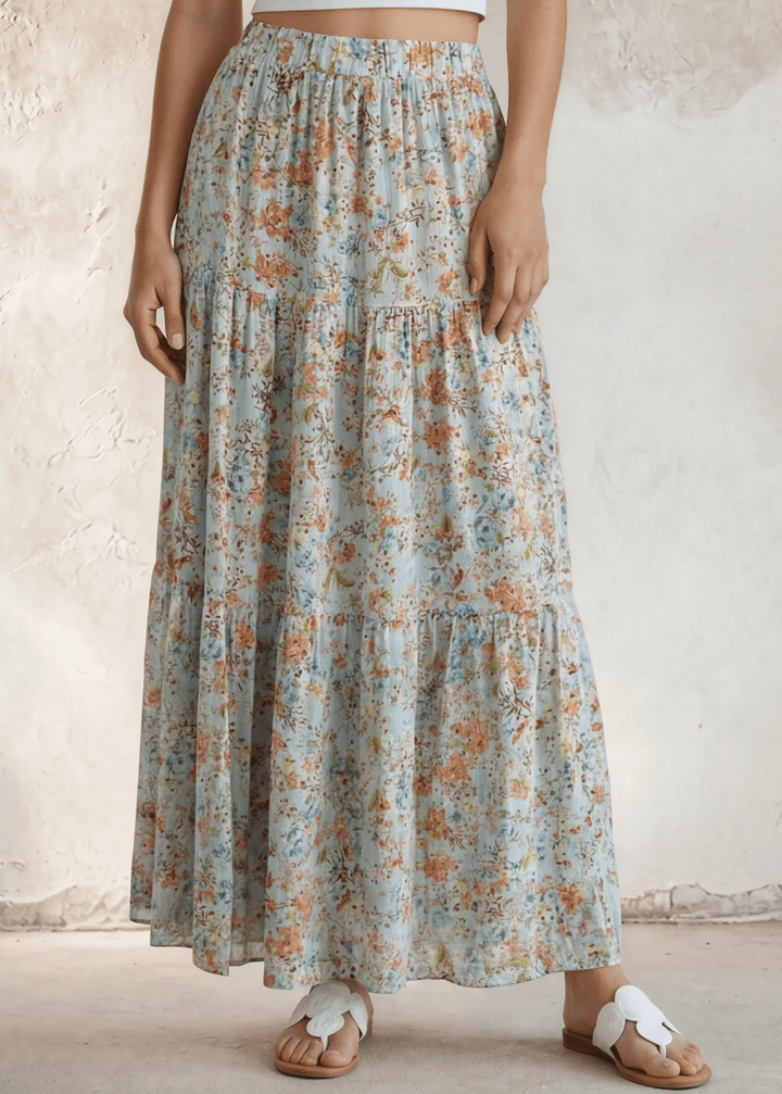 Stunning three-tiered floral pleated maxi skirt in sky blue — 100% rayon, elastic waist, flowy fit. Perfect for spring &amp; summer events. Made in USA.