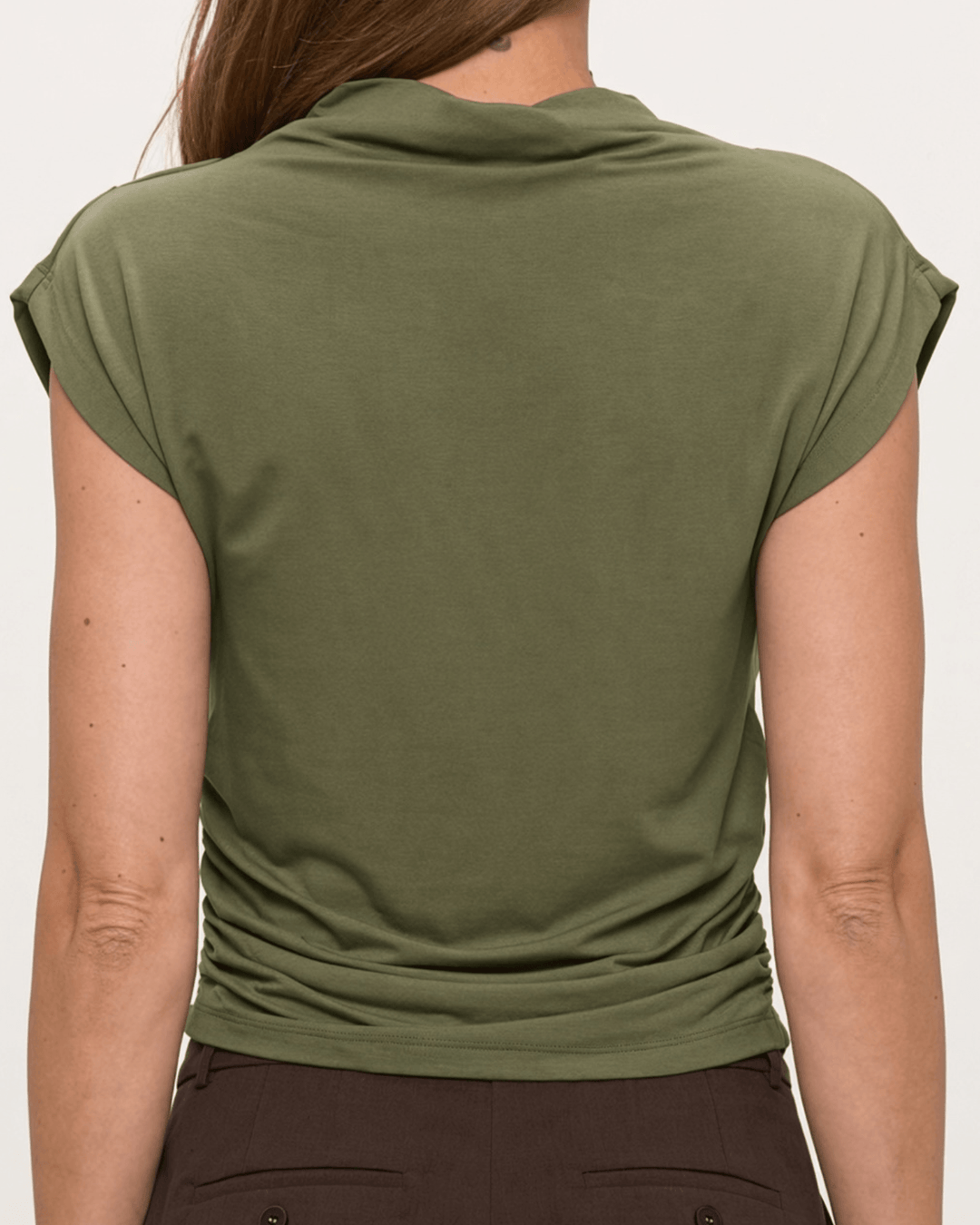Woman wearing, made in USA, the Missy mock neck top pairs soft modal stretch with flattering side ruching. Shop this fitted short-sleeve style in Olive.