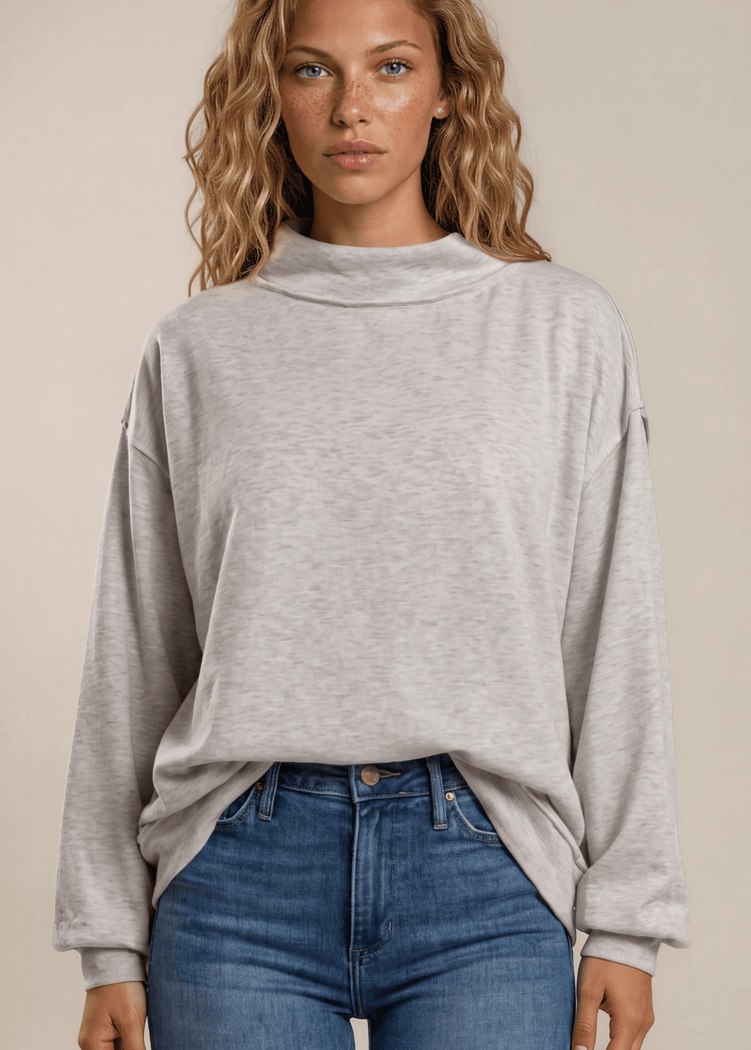 Cozy oversized women's mock neck sweatshirt in heather grey. Drop shoulder, ribbed cuffs, super soft fabric. Made in USA. Sizes S–L.