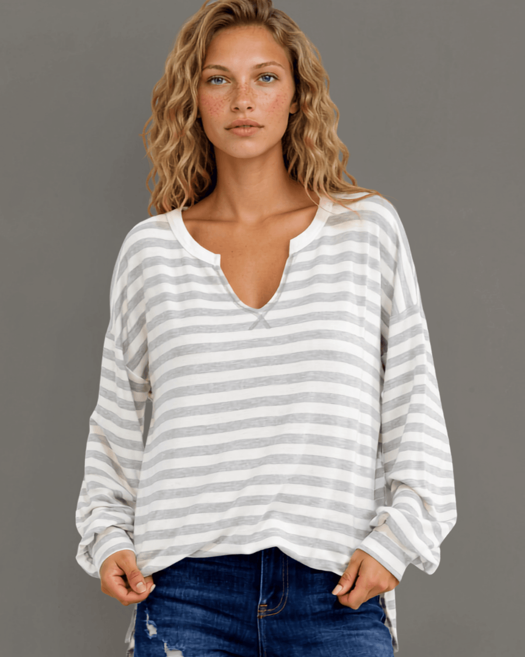 Made in USA. Grey & white striped lightweight oversized pullover. Split V-neck, dropped shoulder, side slits. 68% rayon. Sizes S–XL.
