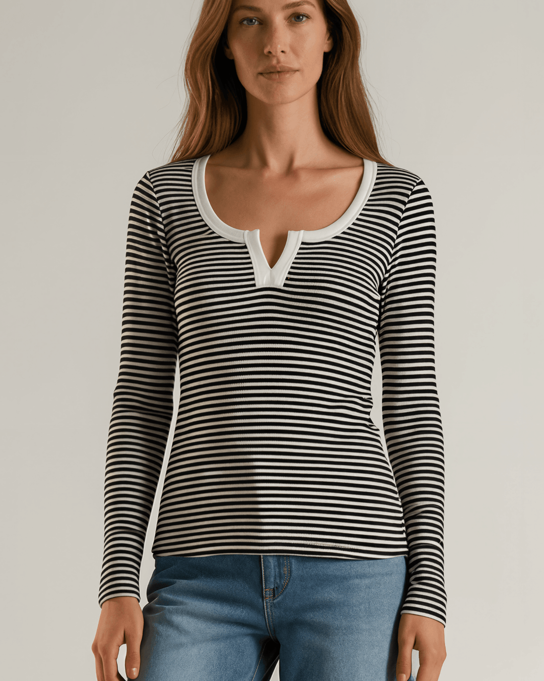 Made in USA. Black &amp; white striped fitted rib knit top. Split V-neck with contrast trim, long sleeves. 97% rayon. Sizes S–XL.