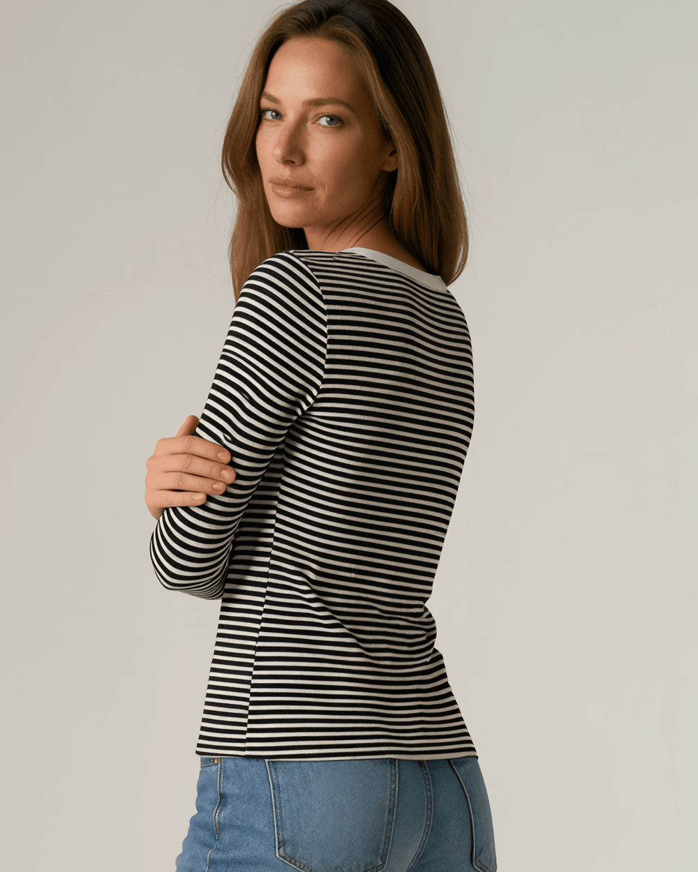 Made in USA. Black & white striped fitted rib knit top. Split V-neck with contrast trim, long sleeves. 97% rayon. Sizes S–XL.