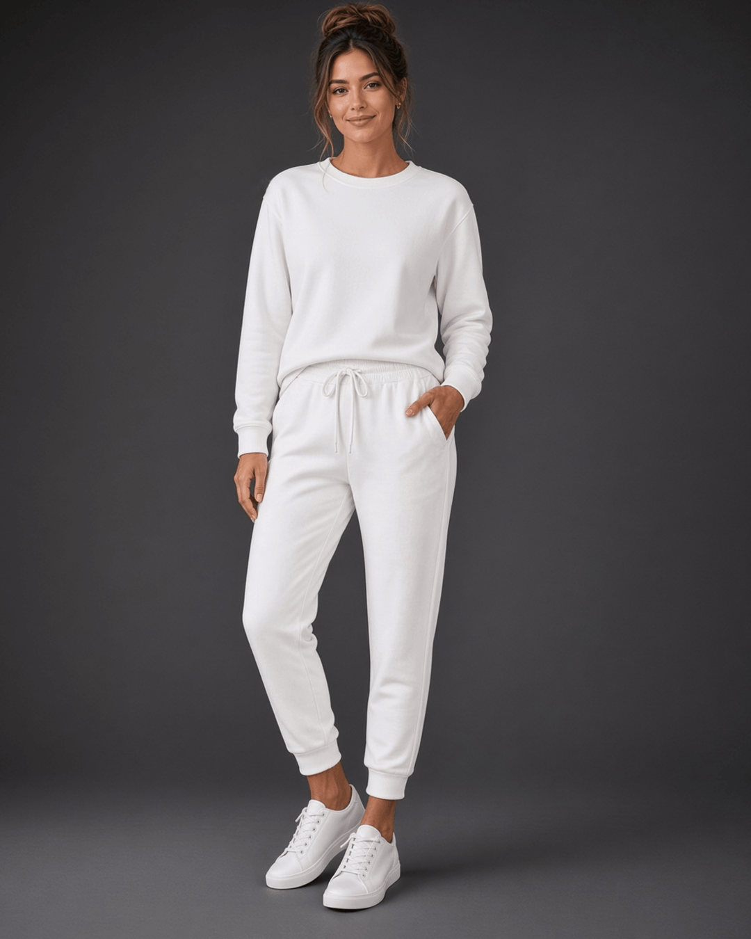 Made in USA, these white cropped joggers blend 62% cotton and 38% polyester, with a relaxed fit, pockets, and cuffed hems. Sizes S–L.