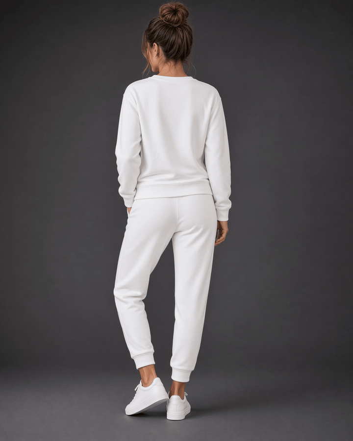 Made in USA, these white cropped joggers blend 62% cotton and 38% polyester, with a relaxed fit, pockets, and cuffed hems. Sizes S–L.