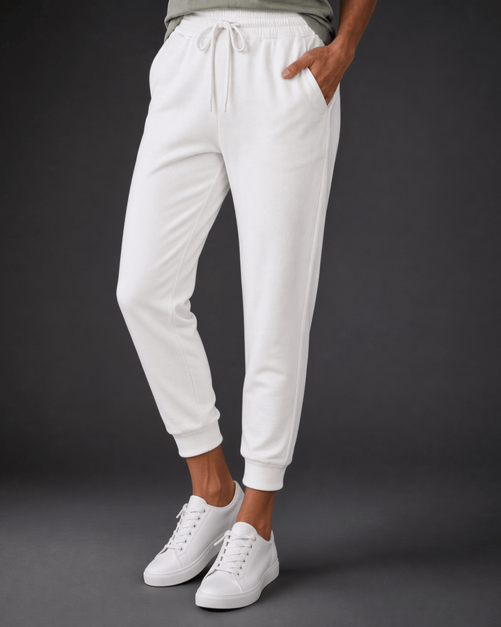 Made in USA, these white cropped joggers blend 62% cotton and 38% polyester, with a relaxed fit, pockets, and cuffed hems. Sizes S–L.