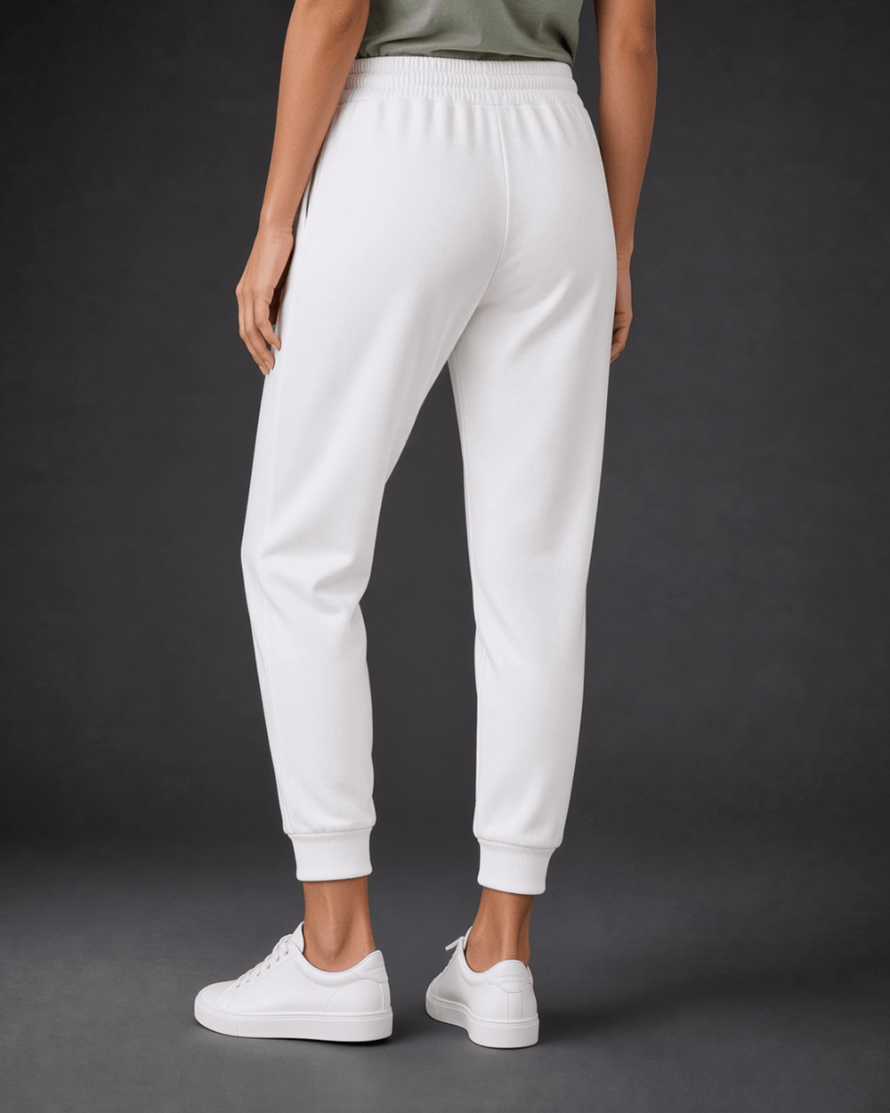Made in USA, these white cropped joggers blend 62% cotton and 38% polyester, with a relaxed fit, pockets, and cuffed hems. Sizes S–L.