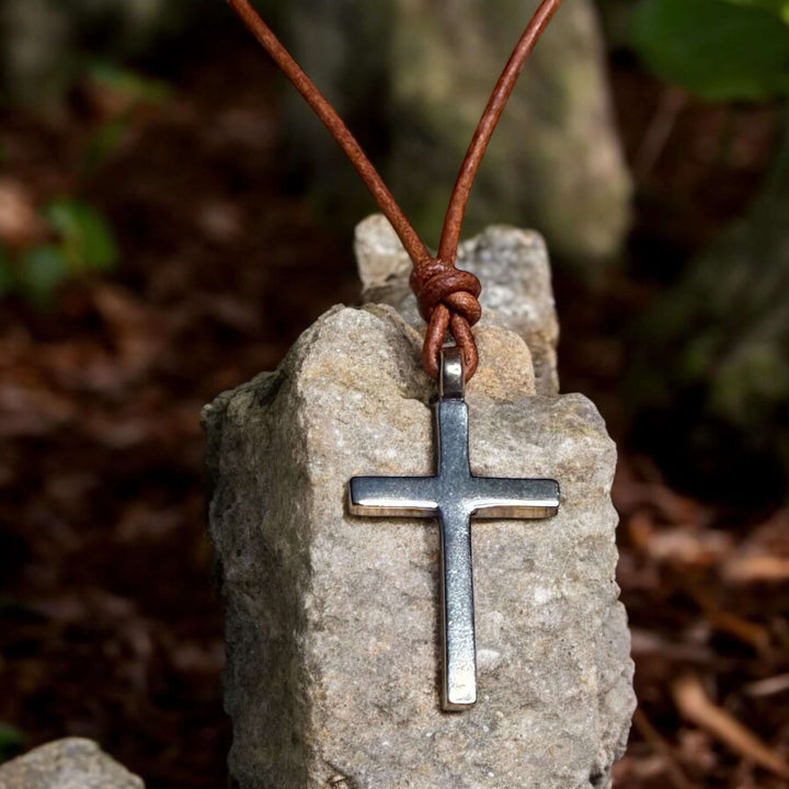 Handcrafted solid bronze cross on an adjustable leather cord. Unisex, red brown or dark brown. Made in USA with a lifetime warranty
