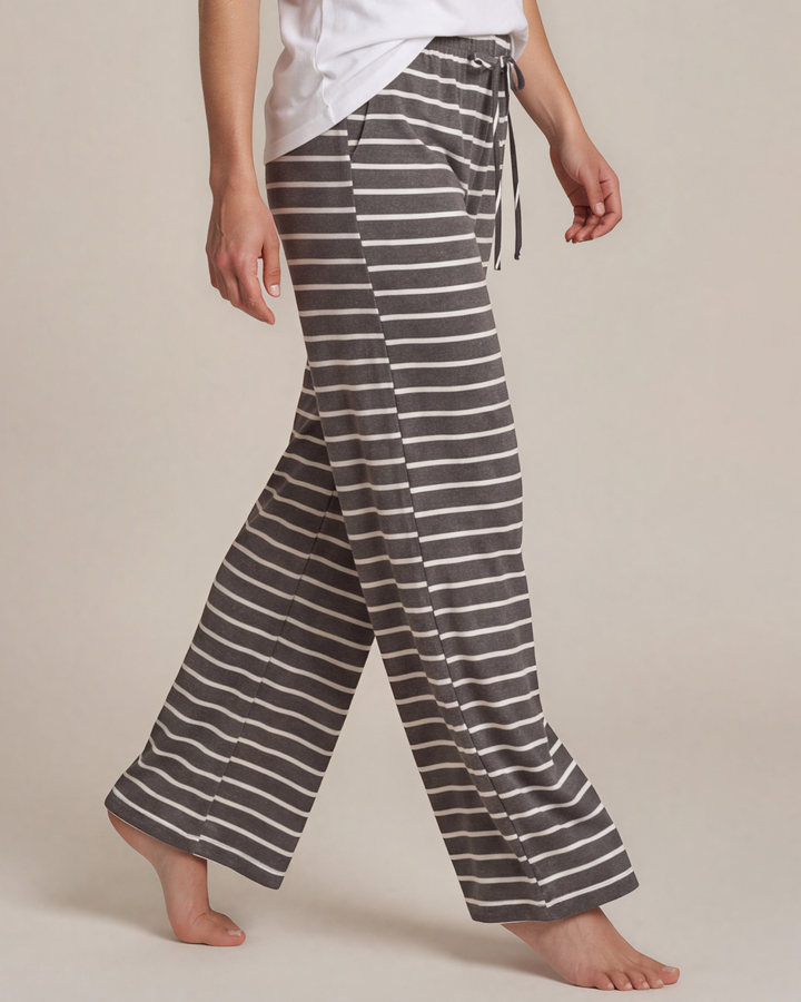 Made in USA. Relax in charcoal striped wide-leg pajama pants with an elastic drawstring waist, side pockets and soft stretch fabric. Sizes S–XL.