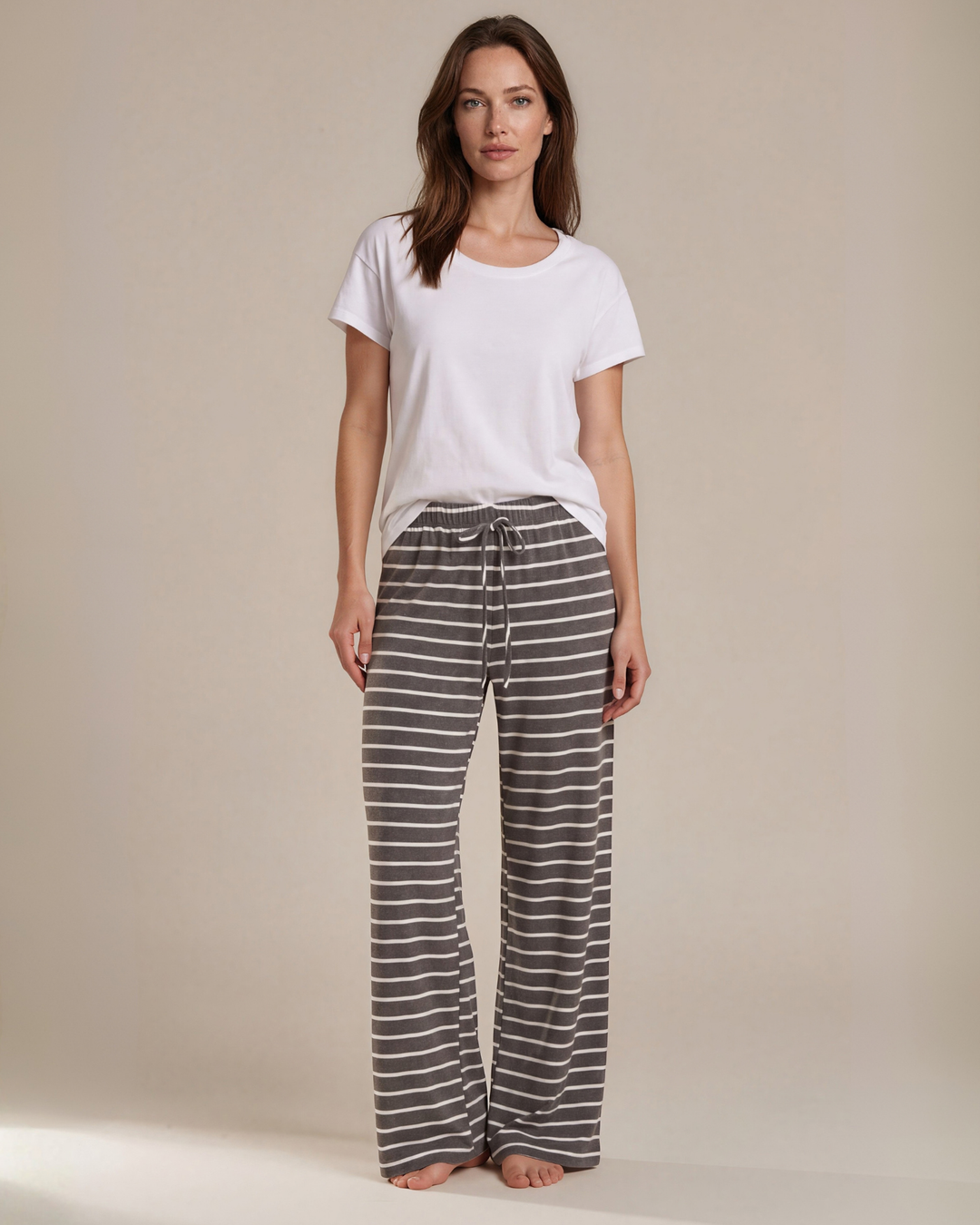 Made in USA. Relax in charcoal striped wide-leg pajama pants with an elastic drawstring waist, side pockets and soft stretch fabric. Sizes S–XL.