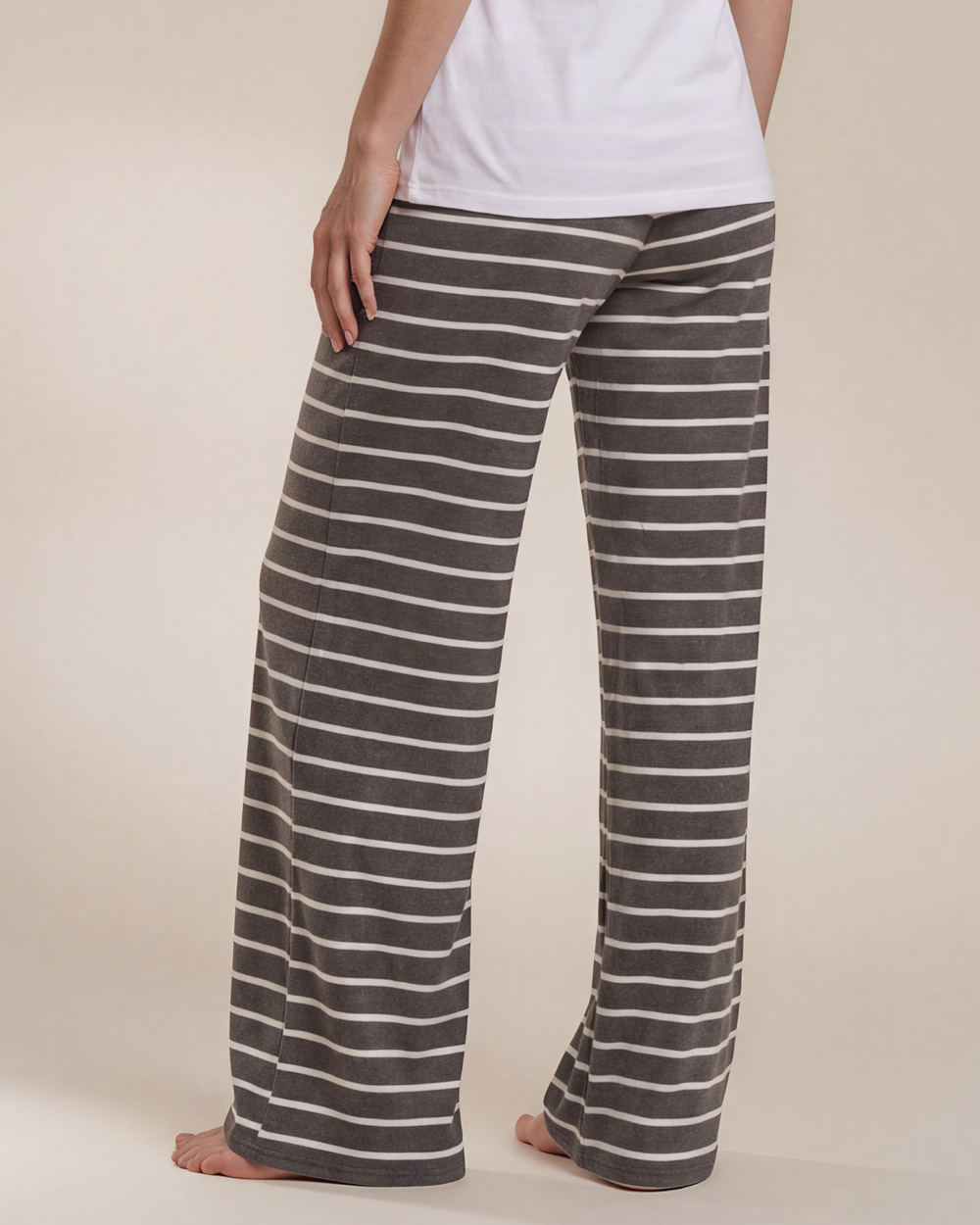 Made in USA. Relax in charcoal striped wide-leg pajama pants with an elastic drawstring waist, side pockets and soft stretch fabric. Sizes S–XL.