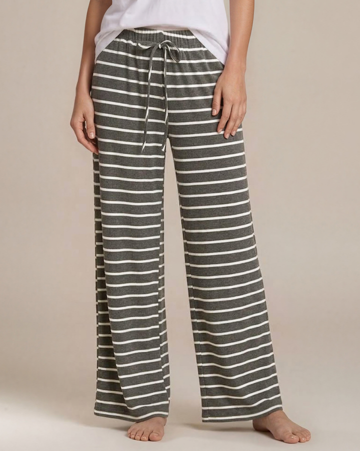 Made in USA. Relax in charcoal striped wide-leg pajama pants with an elastic drawstring waist, side pockets and soft stretch fabric. Sizes S–XL.