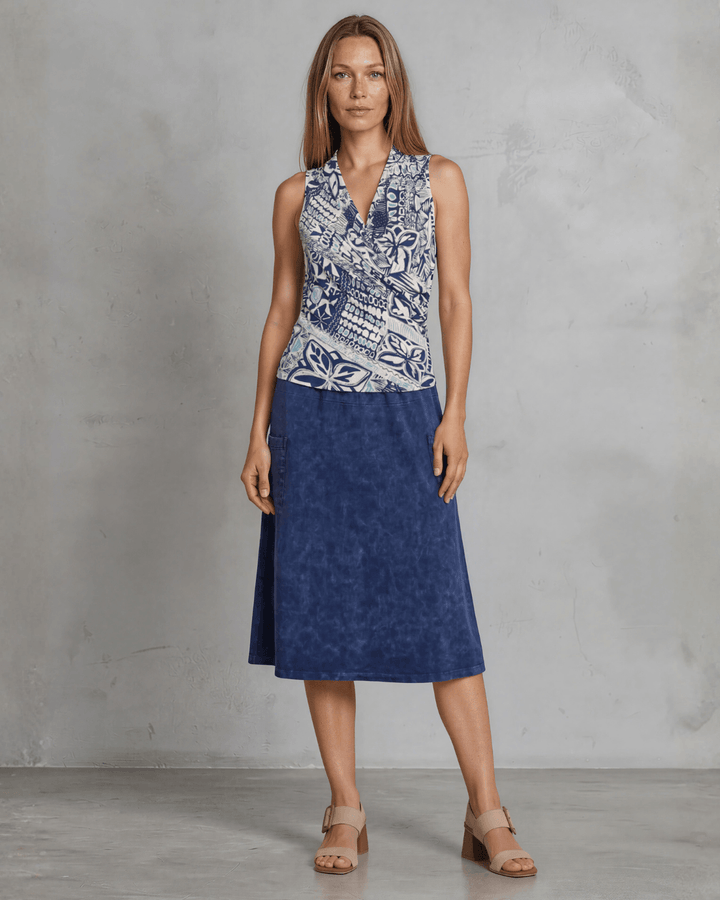 Shop the Karol Knit Surplice V-Neck Sleeveless Top in navy tribal print. Fitted, ruched front, sizes S-L. 95% Poly/5% Spandex. Made in USA.