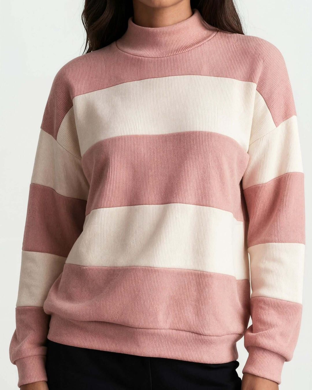 A woman wearing 
Made in USA pink and cream striped mock neck sweater with a relaxed fit, soft stretch knit fabric, long sleeves, and ribbed trim.
