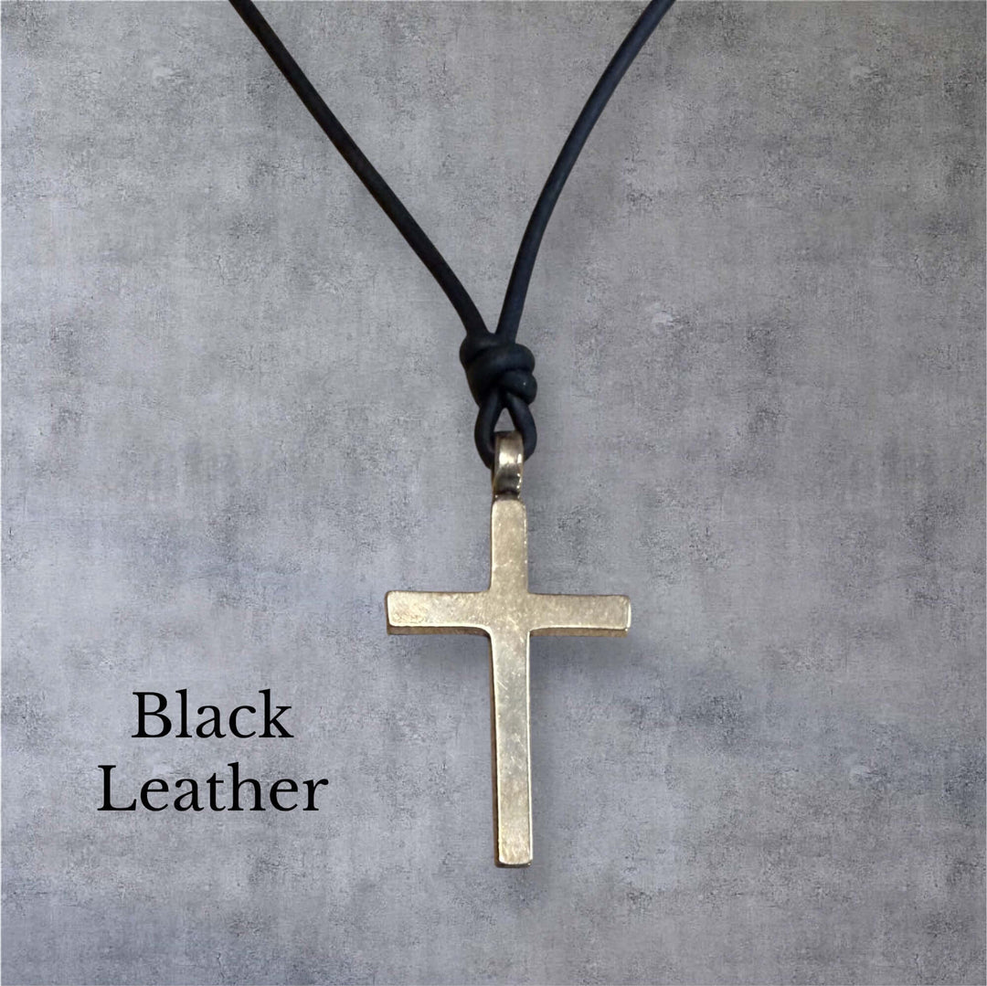 Handcrafted solid bronze cross on an adjustable leather cord. Unisex, red brown or dark brown. Made in USA with a lifetime warranty