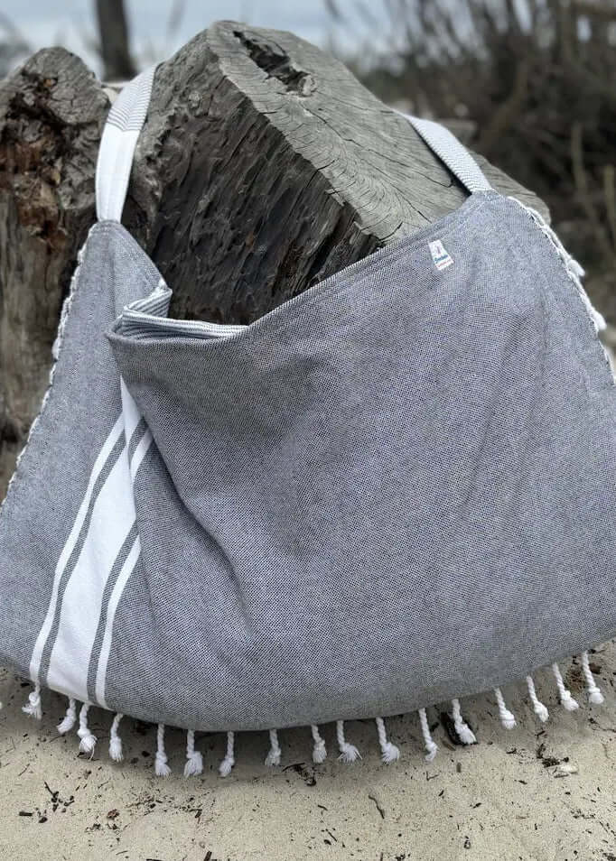 Shop the Beachables Solid 3-in-1 Turkish Cotton Beach Bag – converts from bag to towel to chair cover. Sand-resistant, quick-dry, machine washable. Made in USA.