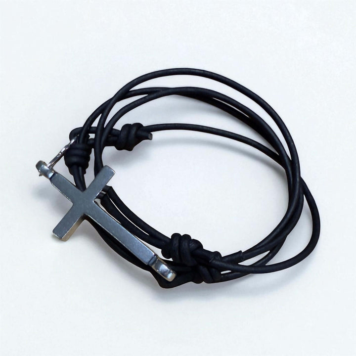 Handcrafted solid sterling silver cross bracelet on a triple-wrap leather cord. One size fits all. Made in USA with a lifetime warranty.