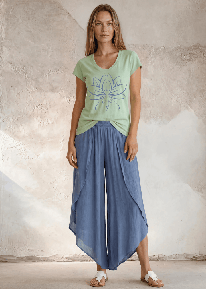 Shop the Meghan Tee — a garment-dyed, fitted scoop neck tee in Neil Green with a Denim Blue Flower Graphic. 50% cotton / 50% modal, ultra-soft. Made in USA.