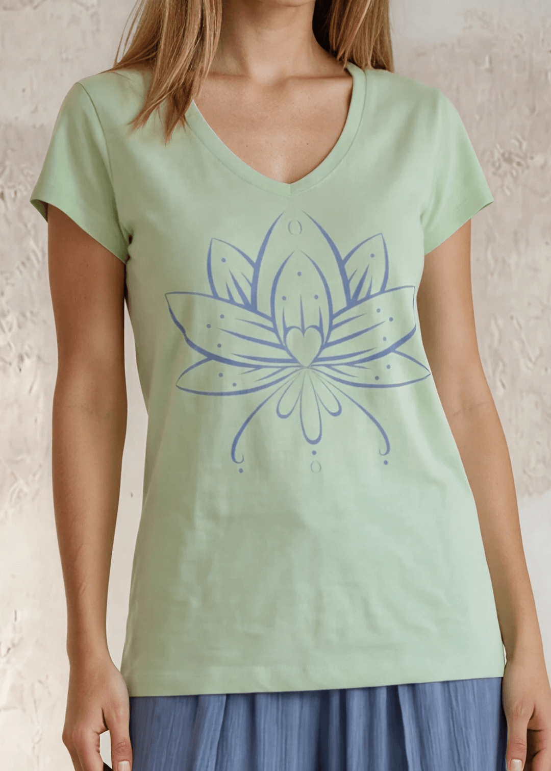 Shop the Meghan Tee — a garment-dyed, fitted scoop neck tee in Neil Green with a Denim Blue Flower Graphic. 50% cotton / 50% modal, ultra-soft. Made in USA.