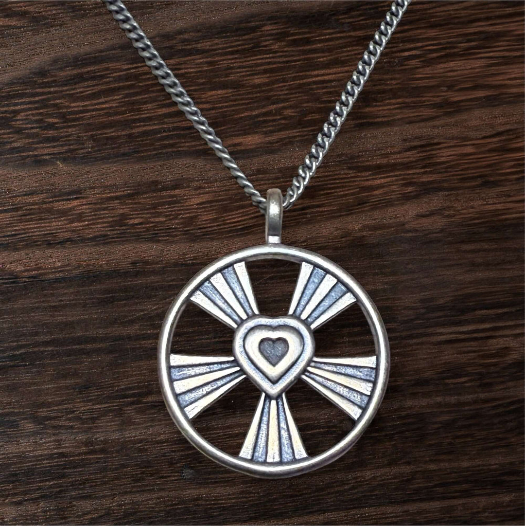 Handcrafted solid bronze shining heart necklace on an antique bronze chain. A timeless gift of love. Made in USA with a lifetime warranty.