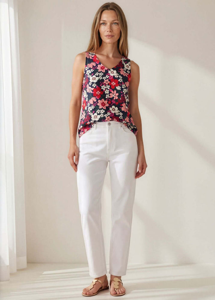 Vivi Vibrant Floral V-Neck Top — a bold navy floral sleeveless top in 95% polyester. Relaxed fit, feminine V-neck. Made in USA.