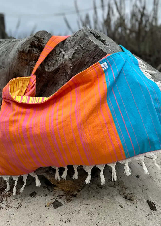 Shop the Beachables Striped 3-in-1 Turkish Cotton Beach Bag – converts from bag to towel to chair cover. Sand-resistant, quick-dry, machine washable. Made in USA.