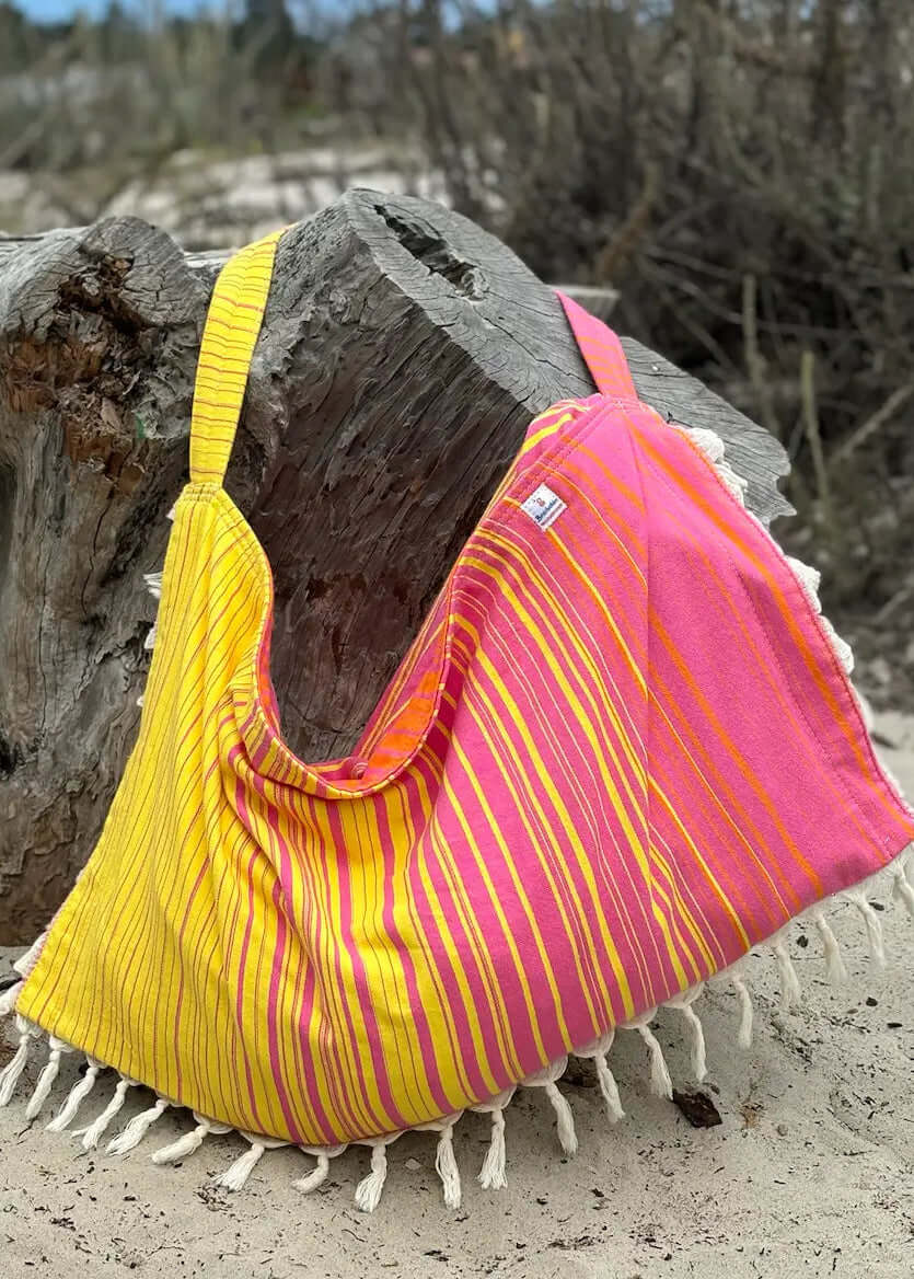 Shop the Beachables Striped 3-in-1 Turkish Cotton Beach Bag – converts from bag to towel to chair cover. Sand-resistant, quick-dry, machine washable. Made in USA.