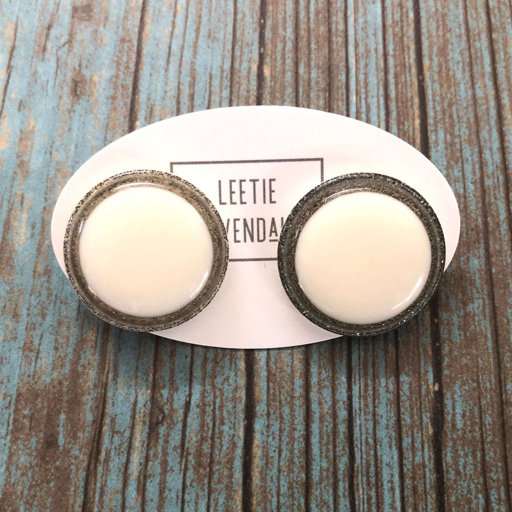 Vintage beveled disc studs in white resin & silver glitter, 24mm. Surgical steel posts, lightweight. 1960s Lucite, handcrafted in the USA.