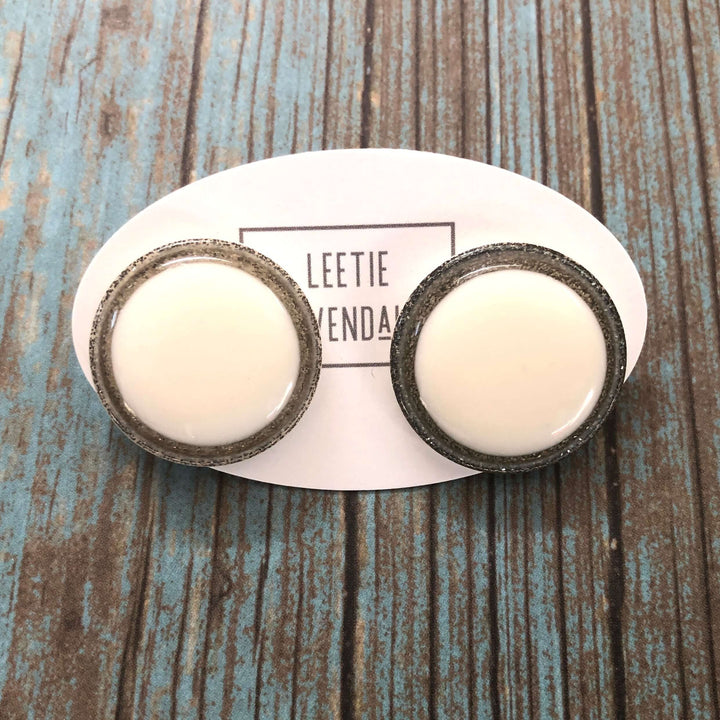 Vintage beveled disc studs in white resin &amp; silver glitter, 24mm. Surgical steel posts, lightweight. 1960s Lucite, handcrafted in the USA.