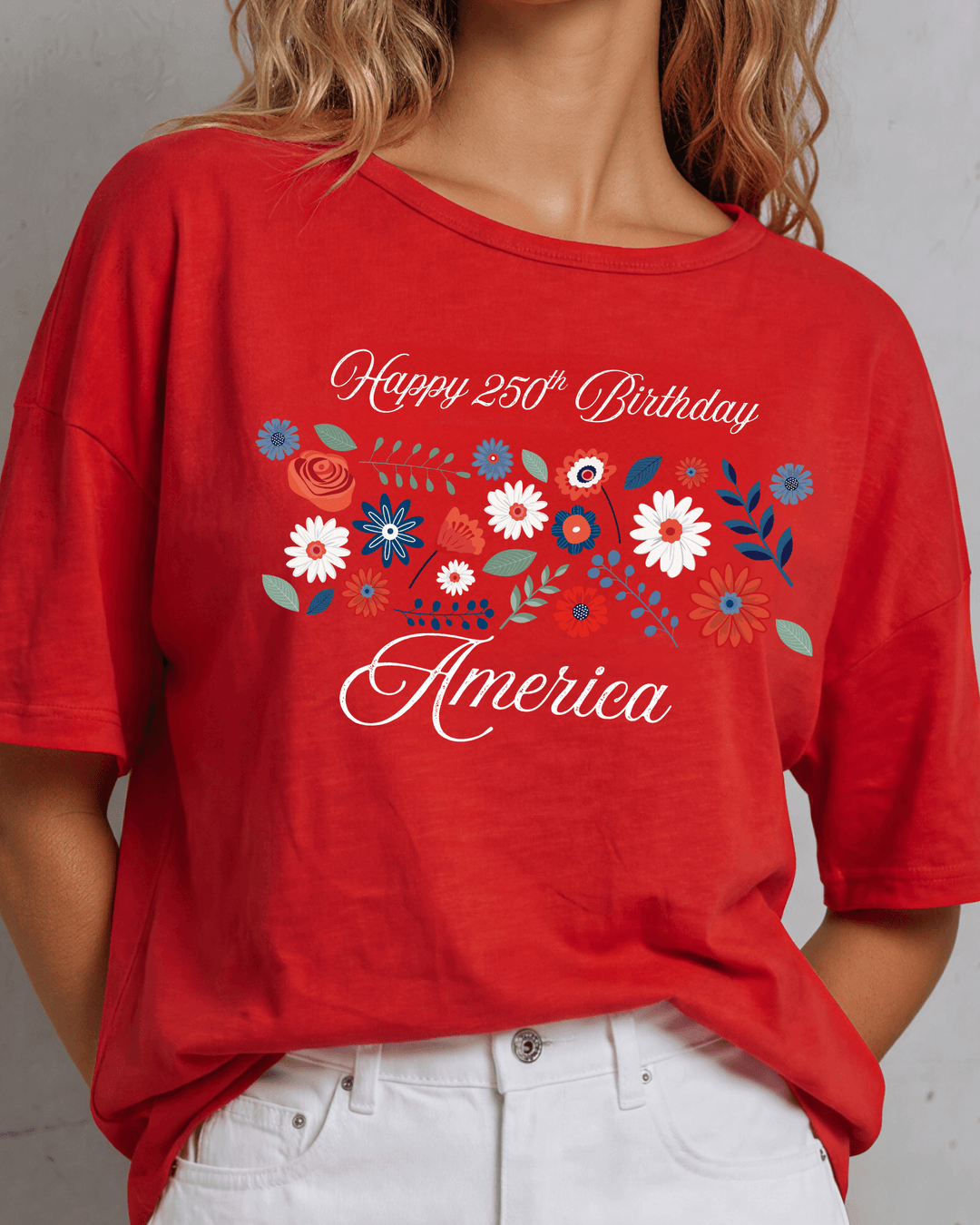 Celebrate America's 250th in this crimson red oversized cotton slub tee with a festive floral graphic. Made in USA. Sizes S–XL.