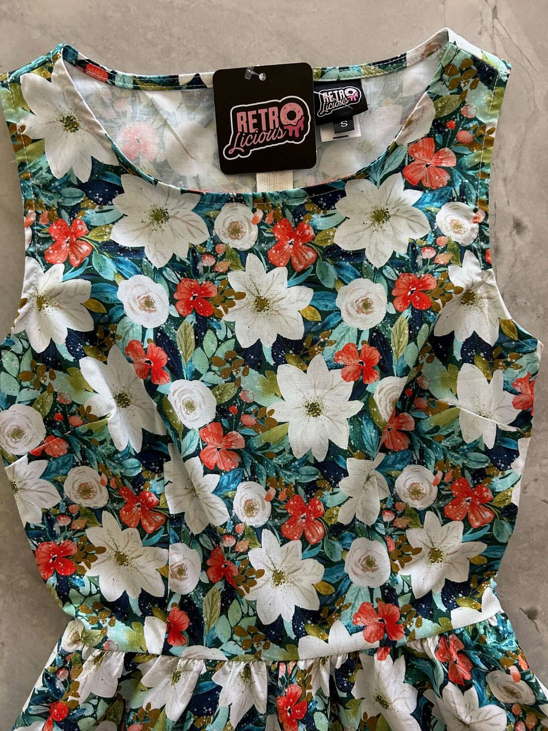 Made in USA. Shop the Winter Floral Vintage Dress by Retrolicious in 100% cotton, with a high neckline, full skirt and hidden pockets. Sizes XS–4X.