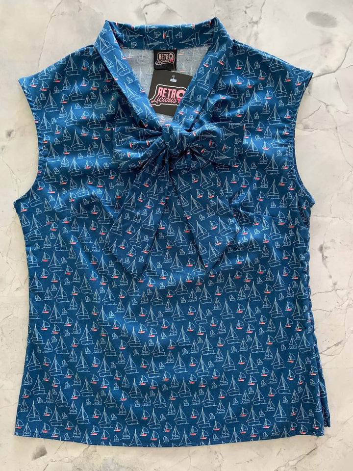 Vintage Tops This top is for the vintage lover at heart! Shown in our sailboats print, this 100% cotton top features bust darts for a flattering silhouette, a side zippered closure for ease of wear, and an oversized bow at the neckline for that perfect 1950&