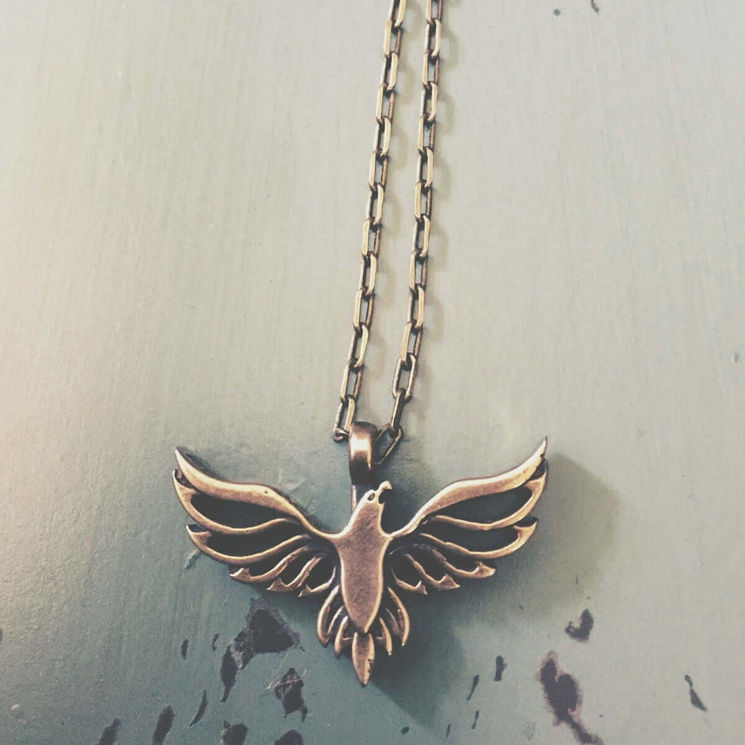 Handcrafted solid bronze eagle necklace on a 20 or 24 inch antique bronze chain. Made in USA with a lifetime warranty.