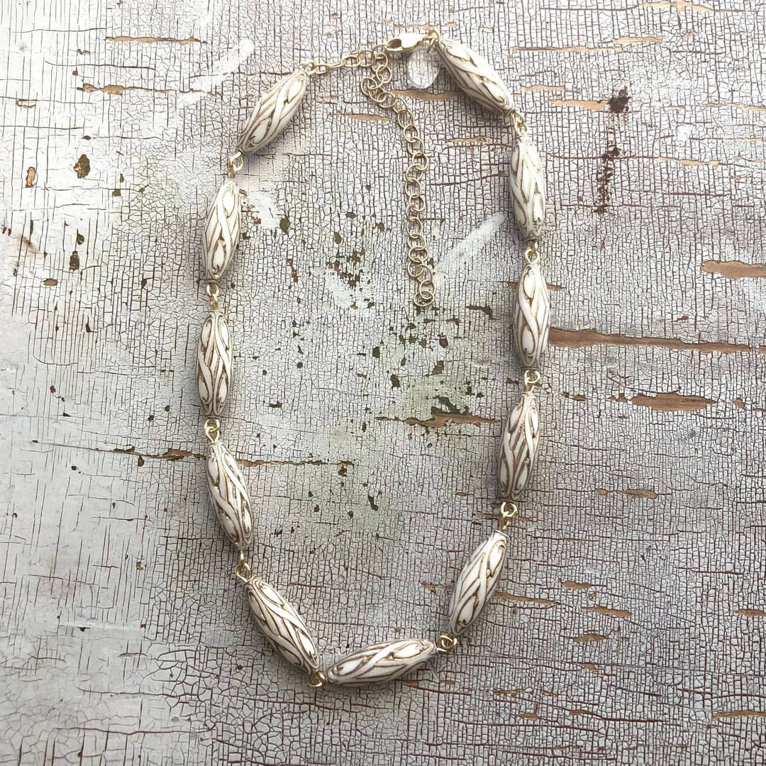 Gold-lined art nouveau white Lucite beads, hand-linked rosary style with laser-cut pendant. 1960s deadstock, 16" + 6" extender. Made in USA.